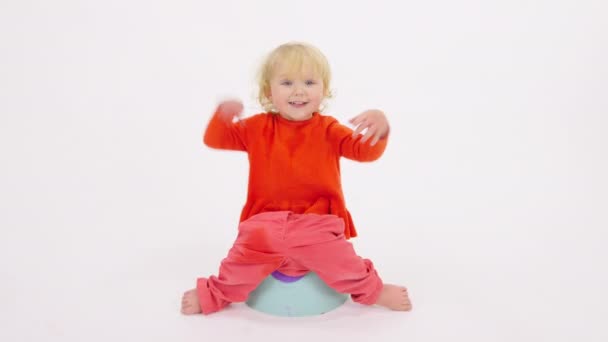 Happy little child sits on childrens potty shows like sign, learning to pee — Stock Video