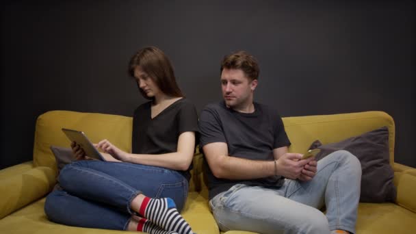 Mann guckt eifersüchtig in das Tablet der Freundinnen, um zu sehen, mit wem sie chattet — Stockvideo