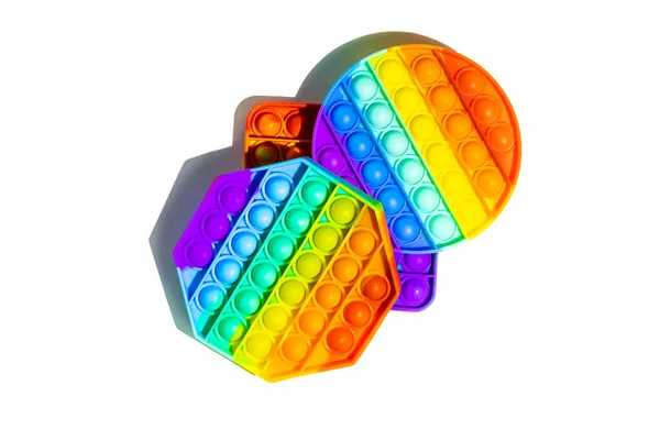 Pop It anti-stress Fidget toys, colorful rainbow game isolated white background Stock Photo