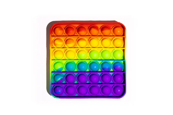 Pop It anti-estrés Fidget juguetes, colorido arco iris juego aislado fondo blanco Fotos De Stock