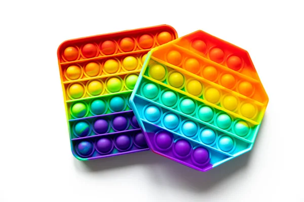 Pop It brinquedos anti-stress Fidget, colorido arco-íris jogo isolado fundo branco — Fotografia de Stock