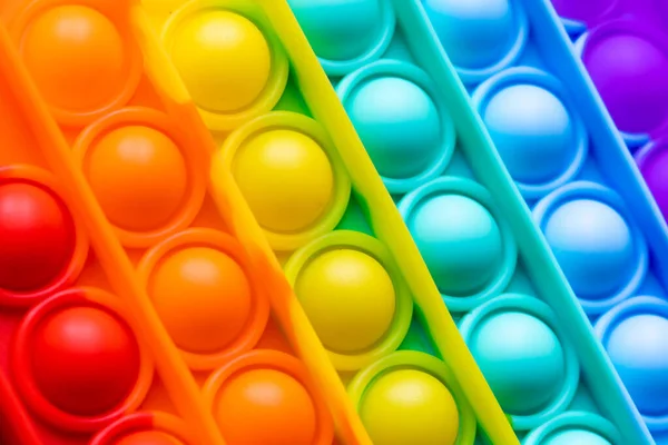 Close-up Pop It textura colorido arco-íris fundo, anti-stress brinquedo Fidget — Fotografia de Stock
