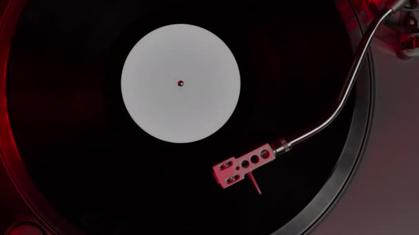 Black vinyl record spinning on turntable LP player in motion top view — Stock Video