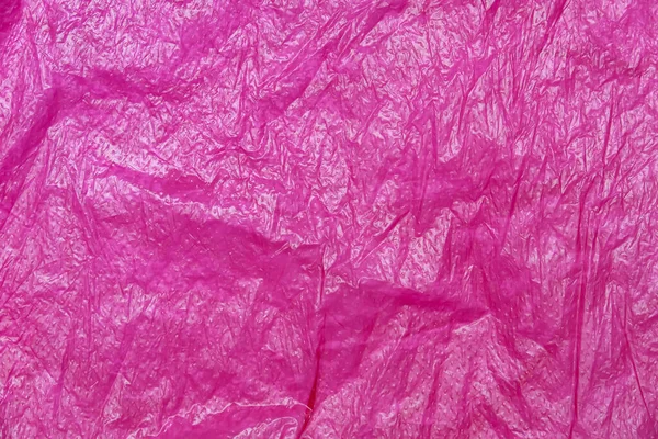 Crumpled red lilac plastic bag abstract texture background surface — Stock Photo, Image