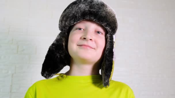 Portrait of a happy smiling laughing caucasian boy wearing winter warm hat with ear flaps — Stock Video