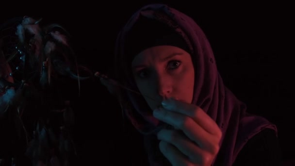 Eine wütende Hexe macht Hexerei und Zauber mit Federn in der dunklen Nacht — Stockvideo