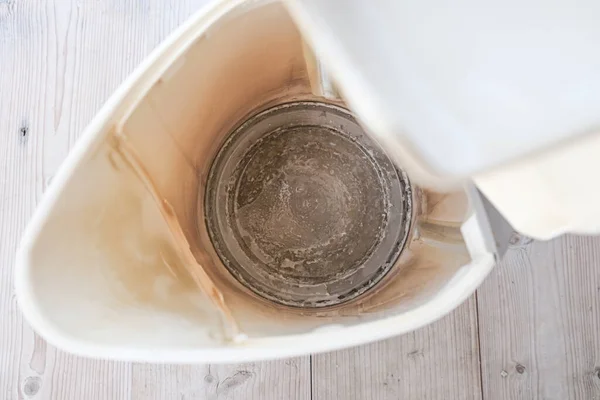 Limescale, lime scale in old kettle in kitchen. A white, chalky residue of calcium carbonate. Household appliances repair caused by hard water.