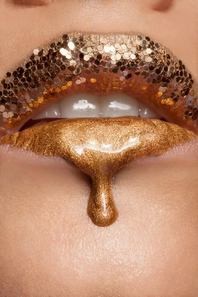Creative make up of gold liquid lips — Stock Photo, Image
