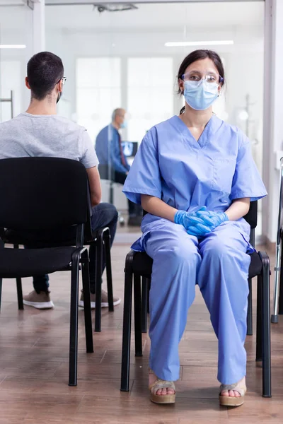 Exhausted assistant in hospital