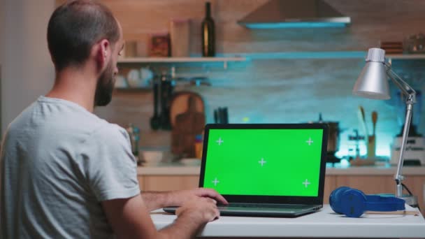 Бизнесмен смотрит на зеленый экран монитора — стоковое видео