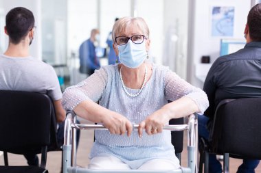 Yürüyen çerçeveli engelli yaşlı kadın