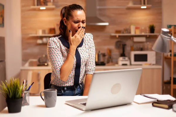 Businesswoman yawning during deadline