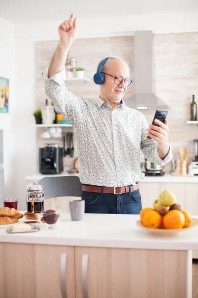 Happy senior man listening music