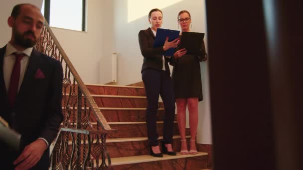 Woman colleagues talking standing on stairs — Stock Video