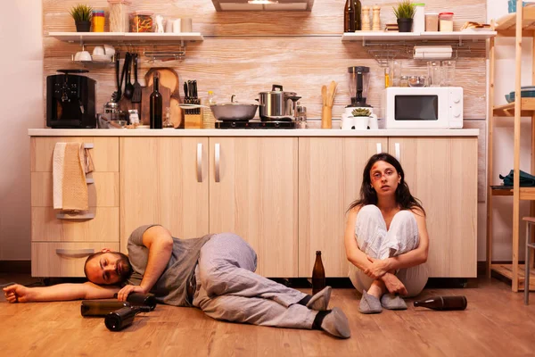 Traumatised wife smoking and crying sitting on the floor — Stock Photo, Image