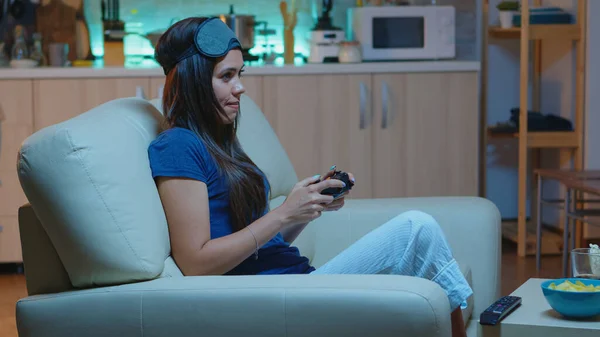 Woman playing video games on console