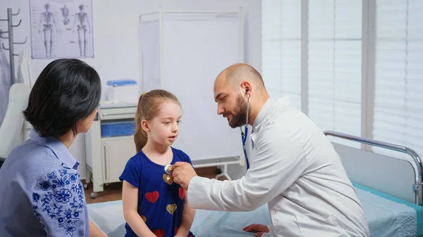 Medical practitioner listening heartbeat — Stock Photo, Image