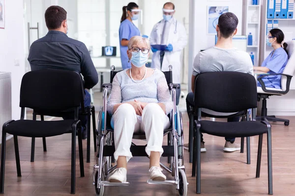 Besorgte gehbehinderte Seniorin sitzt im Rollstuhl — Stockfoto