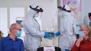 Kapsamlı doktorlar bekleme alanında dijital röntgen üzerinde çalışıyorlar.