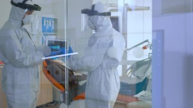 Hasta yakınındaki dişçi ekibi konuşuyor.