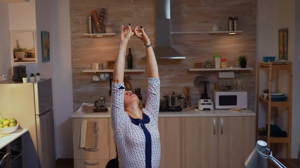 Businesswoman streching while typing on laptop — Stock Photo, Image