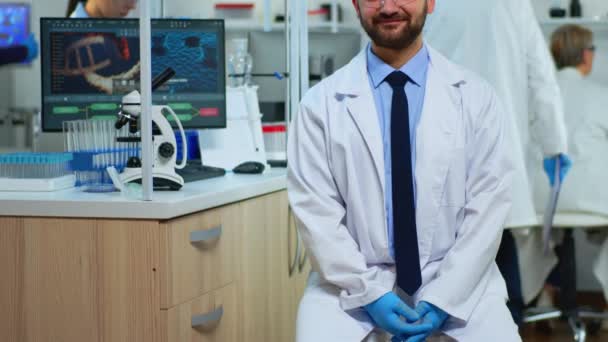 Hombre científico experimentado mirando a la cámara sonriendo — Vídeo de stock