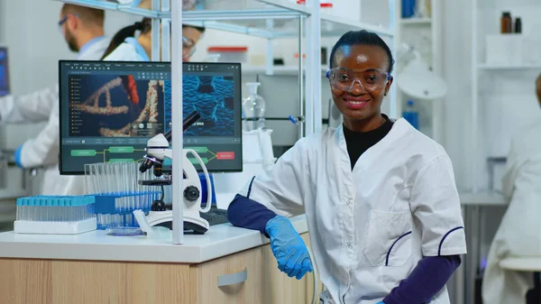 Professional black woman scientist looking at camera smiling