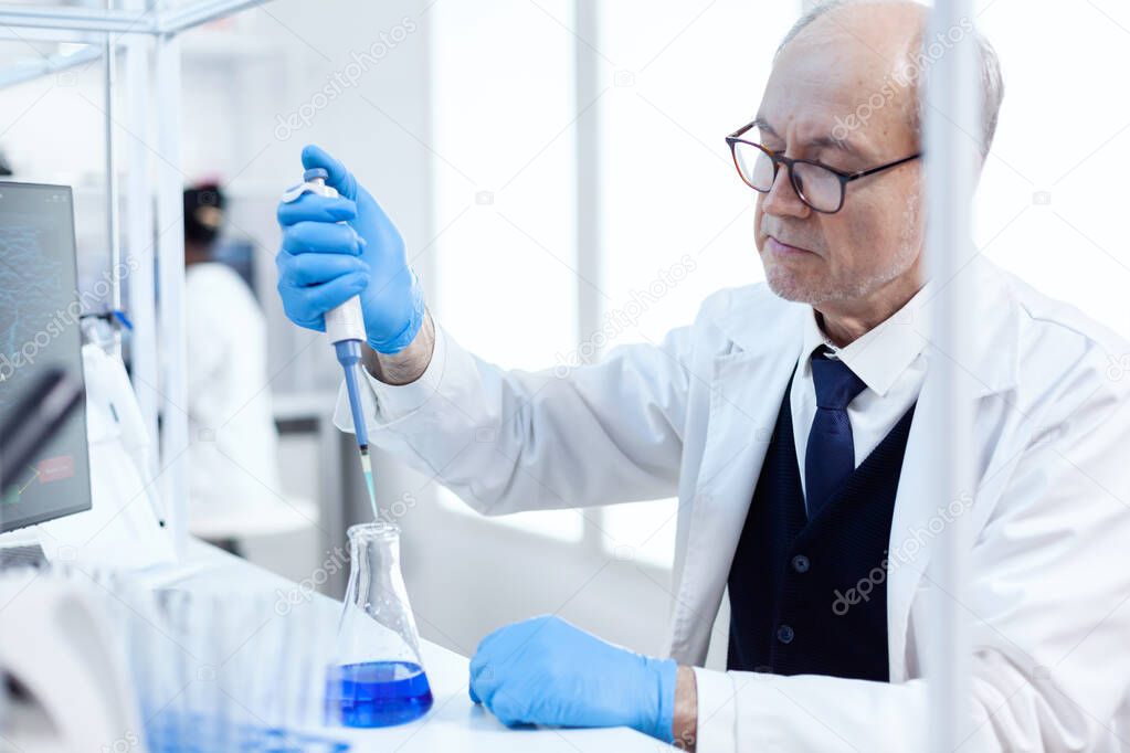 Elderly scientist doing genetic experiment