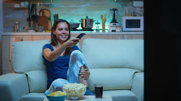 Kobieta je popcorn na kanapie — Zdjęcie stockowe