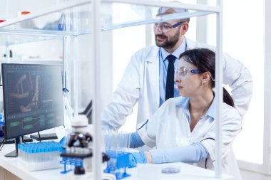 İki bilim adamı laboratuarda birlikte çalışıyorlar.