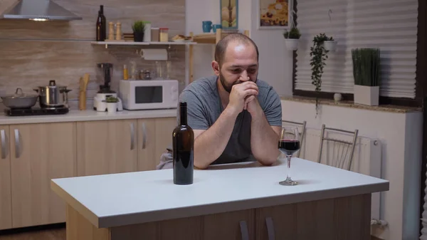 Sad husband drinking in the kitchen — Stock Photo, Image