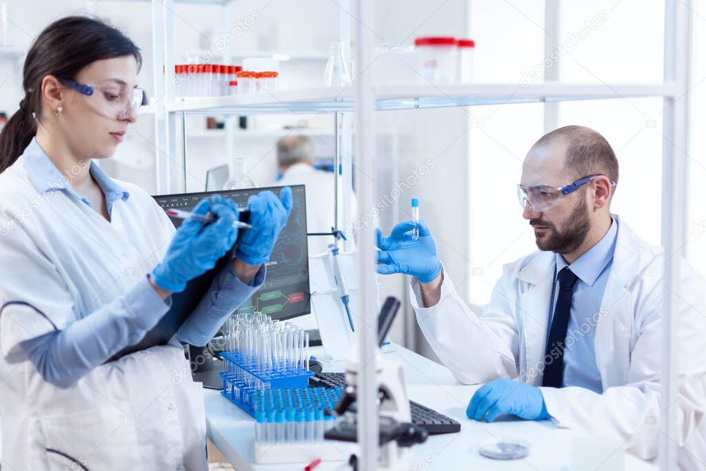 Group of scientist conducting and engineering genetic material