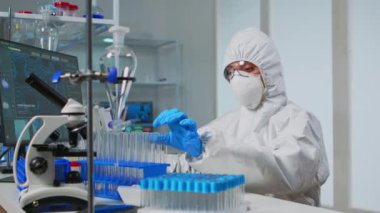 Laboratuvar teknisyeni sıvı örneklerini inceliyor.