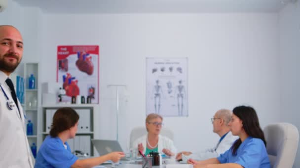 Portrait of young man doctor smiling at camera — Stock Video