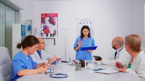 Attentive medical team discussing medicine problems using tablet — Stock Video