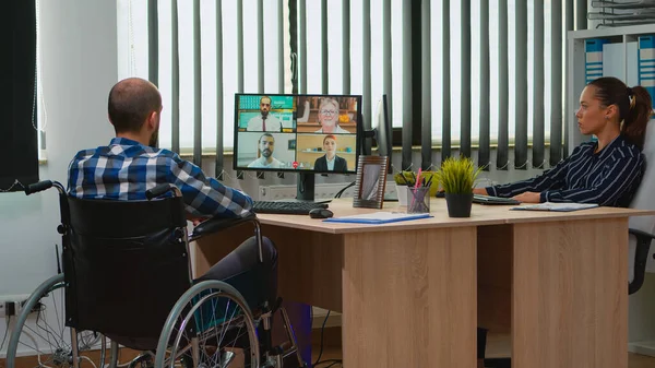 Immobilized freelancer in wheelchair having videomeeting — Stock Photo, Image