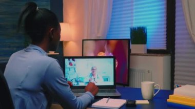 Online tıbbi danışmanlık sırasında Afrikalı kadın notlar yazıyor.
