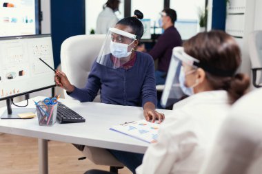 Müşteri ya da meslektaşlarına yıllık mali raporlarını gösteren odaklanmış Afrikalı analist