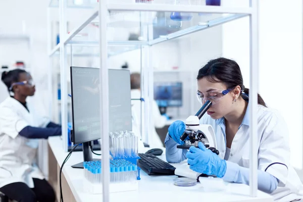 Especialista em genética fazendo pesquisa usando microscópio — Fotografia de Stock