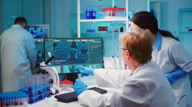 Kıdemli biyokimyacı aşıdaki değişiklikleri bilgisayarda yazıyor.