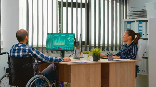 Businessman in wheelchair working in business office — Stock Photo, Image