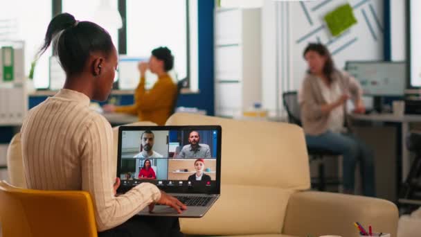 Gestora africana discutiendo con colegas remotos usando videollamada — Vídeos de Stock