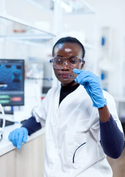 Afrykańska biochemia patrząc na próbkę na szkiełku — Zdjęcie stockowe