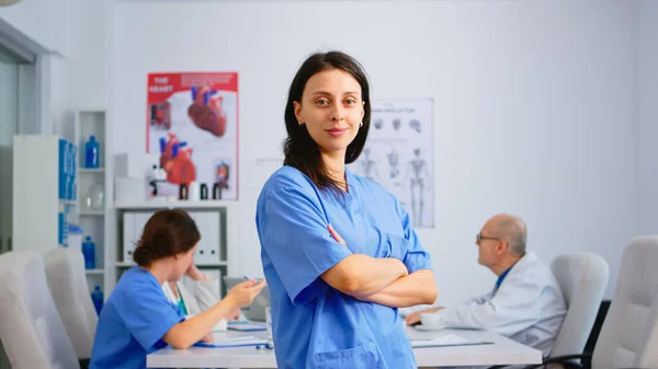 Infirmière debout devant la caméra souriant — Photo