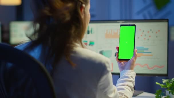 Фрилансер смотрит на мобильный телефон с зеленым экраном — стоковое видео