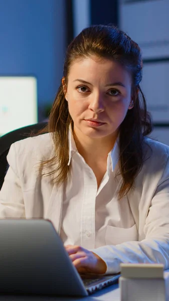 Tired woman manager raising head looking at camera sighing — Stock Photo, Image