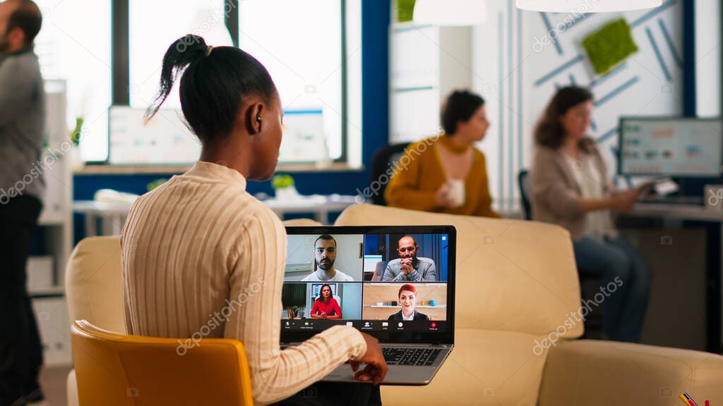 African manager woman discussing with remote colleagues using video call