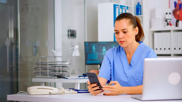 Medical nurse consulting patient online using smartphone