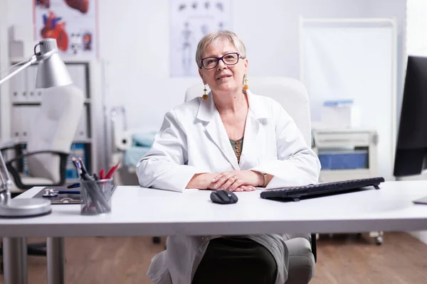 Chefarzt lächelt bei Videotreffen mit Patienten — Stockfoto