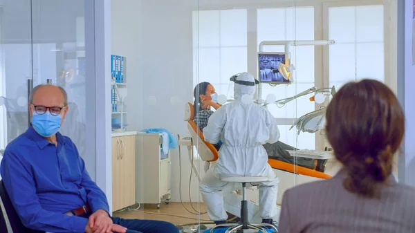 People with protection masks discussing in reception area